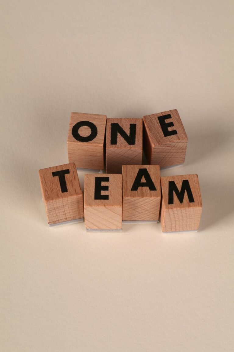 Wooden blocks arranged to spell 'One Team', symbolizing teamwork and unity.